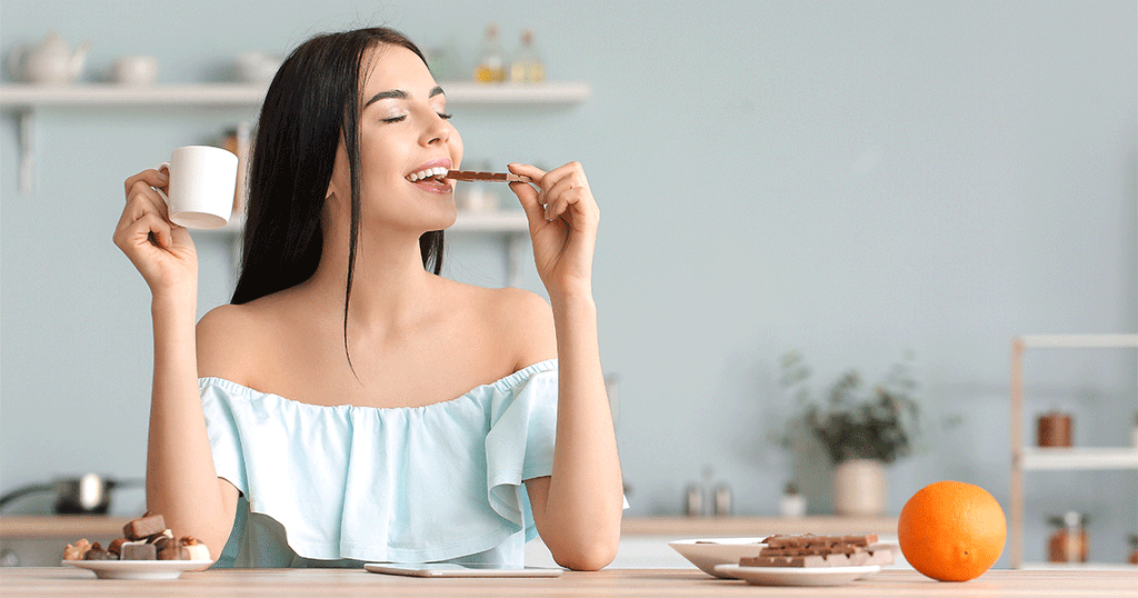 امرأة تتناول الشوكولاتة مع القهوة